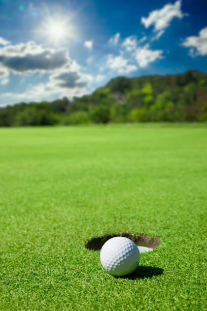 istock Golf Ball By Edge of Hole 1271199595