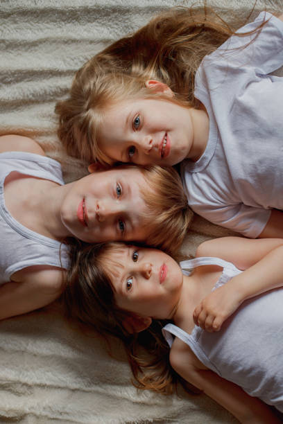 istock three children are lying next to each other. 1271199772
