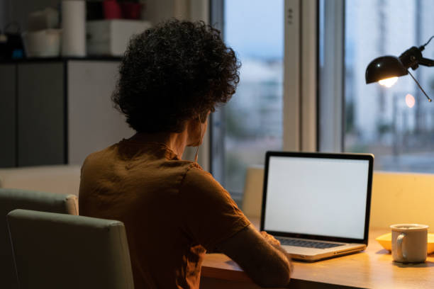 istock Adult Man With Curly Hair Using Notebook Computer At Home 1271201050