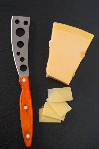 istock cheese knife with a wooden handle over black 1271205696