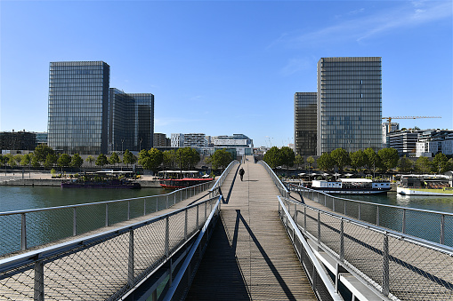 Paris, France-09 07 2020: View of the Bibliothèque nationale de France, François-Mitterrand site, located in Paris. The Bibliothèque nationale de France or National Library of France is a public establishment under the supervision of the Ministry of Culture. Its mission is to constitute collections, especially the copies of works published in France that must, by law, be deposited there, conserve them, and make them available to the public.