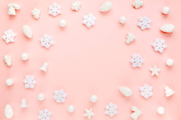 istock Christmas frame with white christmas snowflakes on pink background. Christmas composition, wallpaper. Flat lay, top view 1271209513