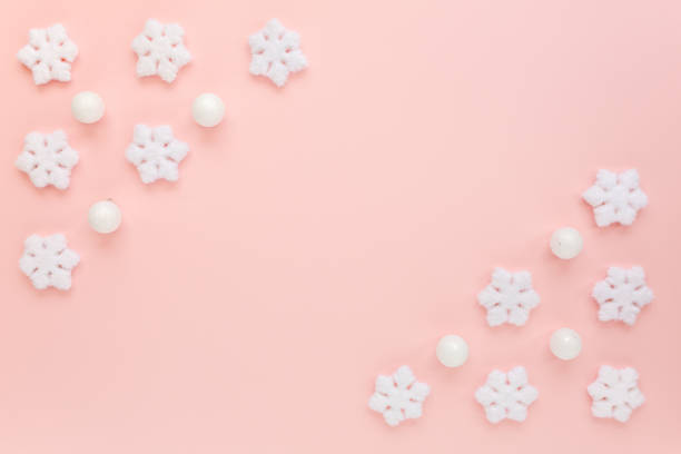 istock Christmas frame with white christmas snowflakes on pink background. Christmas composition, wallpaper. Flat lay, top view 1271209732