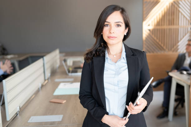 confident female lawyer in office - lawyer young adult suit expressing positivity imagens e fotografias de stock