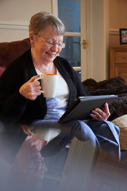 istock Senior woman reading online 1271215944