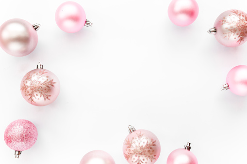 Stylish arrangement, frame of pink christmas balls on white background. Flat lay, top view. High quality photo