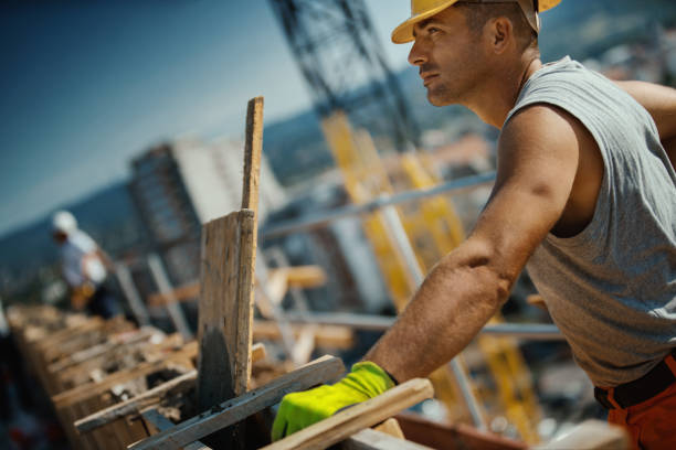 istock Construction workers finishing rooftop wall on the apartment building. 1271218816