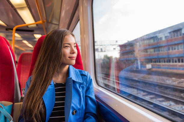 Train woman leaving for work in morning commute commuting to city. Urban travel businesswoman traveling on rails Train woman leaving for work in morning commute commuting to city. Urban travel businesswoman traveling on rails. central london stock pictures, royalty-free photos & images