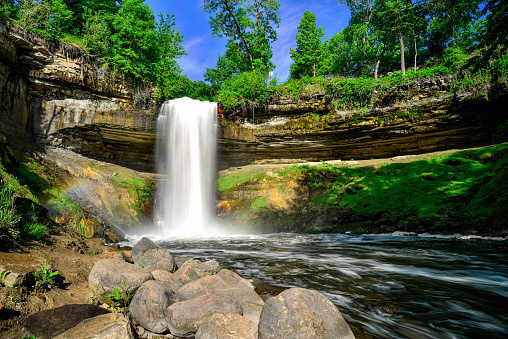Lush and Green Minnehaha Falls in Minneapolis, Minnesota. A waterfall in the city limits of Minneapolis that is a popular tourist destination.