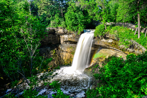 Lush and Green Minnehaha Falls in Minneapolis, Minnesota. A waterfall in the city limits of Minneapolis that is a popular tourist destination.