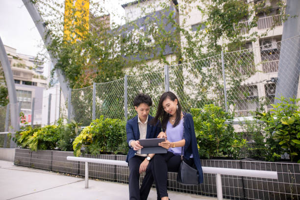 istock Young business people working in public park 1271222078