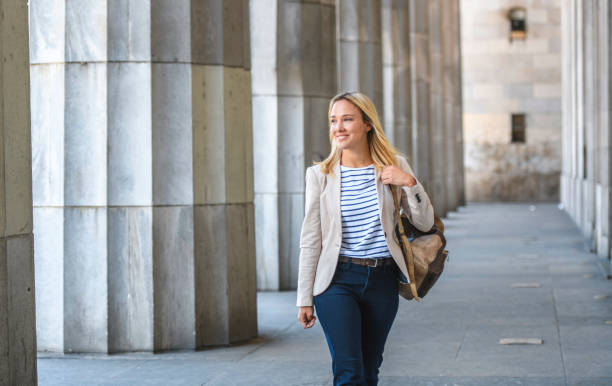 istock Relaxed Young Law Student with Backpack Walking on Campus 1271229425