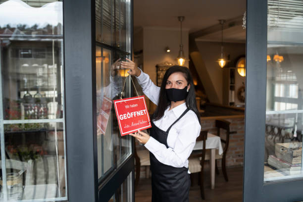 istock Open sign in a small restaurant or cafe after Coronavirus pandemic 1271230189