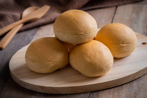 istock Bread roll or bun on wooden board 1271230623