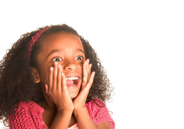 little girl calling out excitedly, hands to mouth - surprise child little girls shock imagens e fotografias de stock