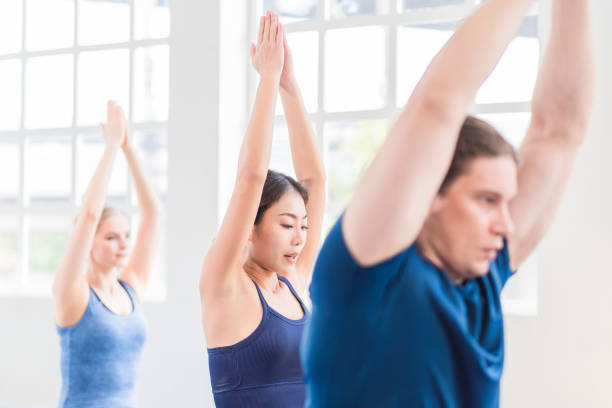 istock Multi ethnic group of people (Asian, Caucasian) in yoga class together 1271240983