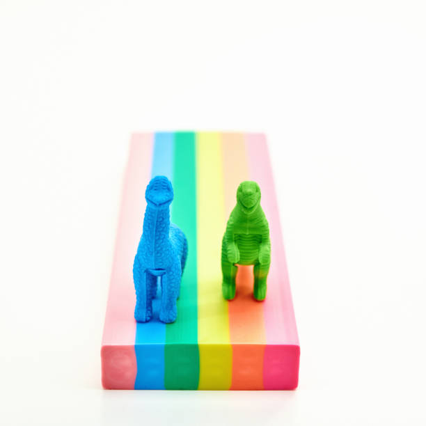 istock Cute dinosaurs racing on rainbow colored road 1271241795