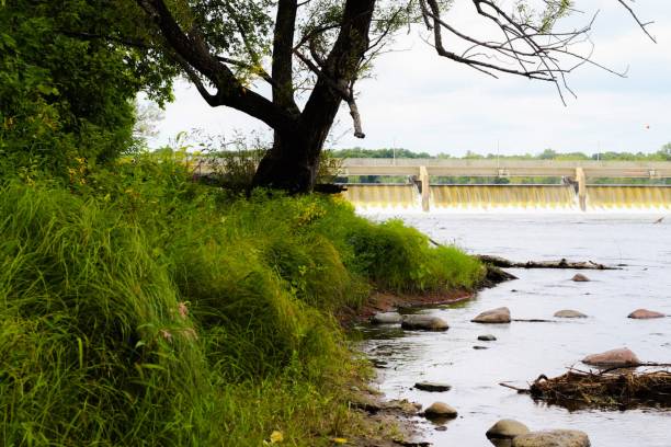 istock Scenic river bank view with dam 1271242574