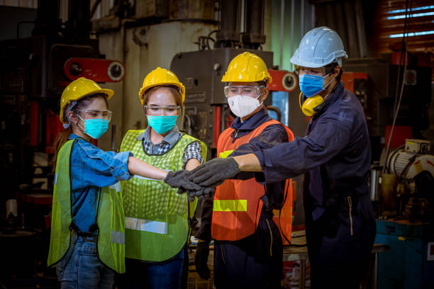 istock Portrait woman worker and engineer  under inspection and checking production process on factory station by wearing safety mask to protect for pollution and virus in factory .They good signal in work. 1271247716