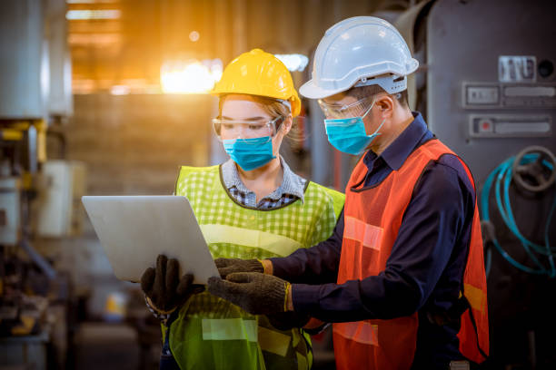 istock Portrait woman worker and engineer under inspection and checking production process on factory station by wearing safety mask to protect for pollution and virus in factory 1271247792