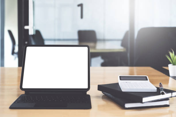 istock Digital tablet with blank screen on wooden desk. 1271251897