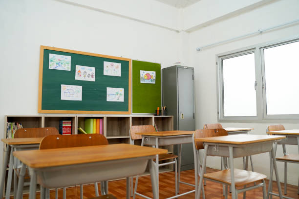 istock Empty classroom and desks preparation in primary school building in Asia. Elementary school interior 1271251960