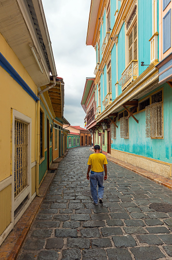 Ecuadorian man walking in a colorful colonial style street, Guayaquil, Ecuador.