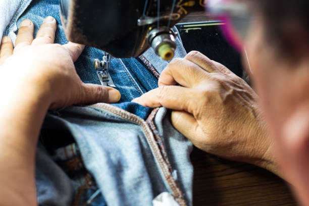 istock Above hand repaired jeans with an old machine. 1271254308