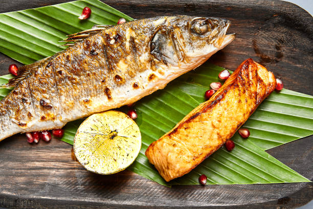 istock Fish served on wooden rustic plate 1271254332