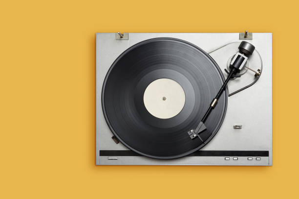 istock Vinyl player with long play or LP record on yellow background. 1271255067