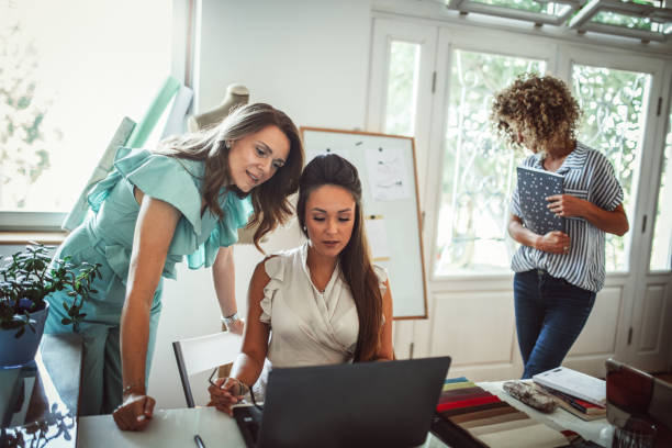 istock Group of young business people working and communicating while sitting at the office 1271260932
