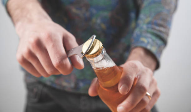 istock Man opening a bottle of beer. 1271260993