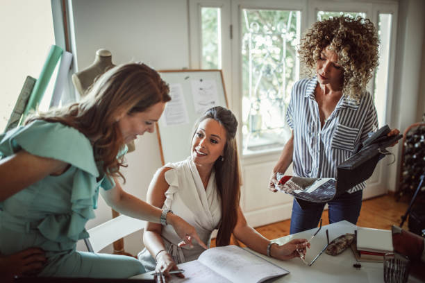 istock Group of young business people working and communicating while sitting at the office 1271261127