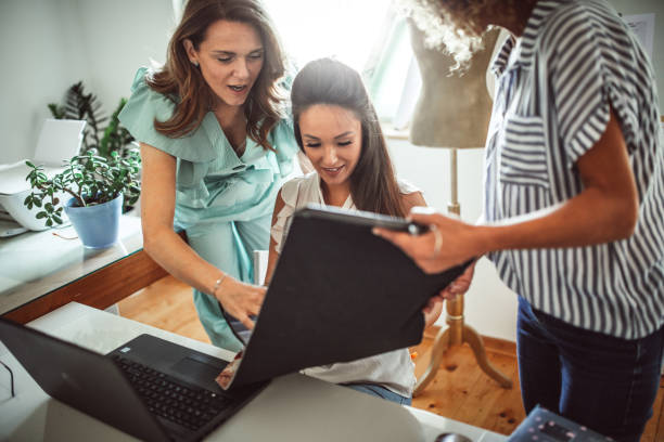 istock Group of young business people working and communicating while sitting at the office 1271261234