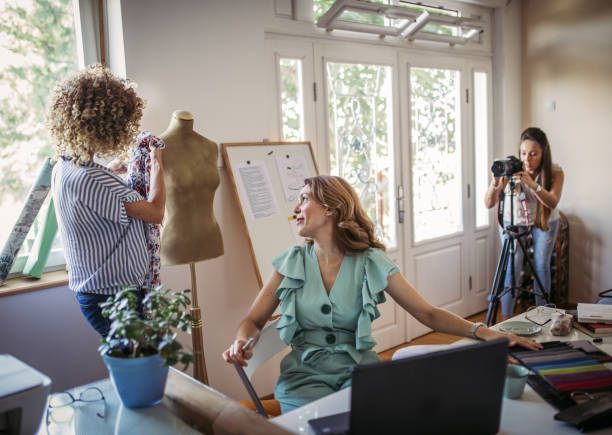 istock Group of young business people working and communicating while sitting at the office 1271261996