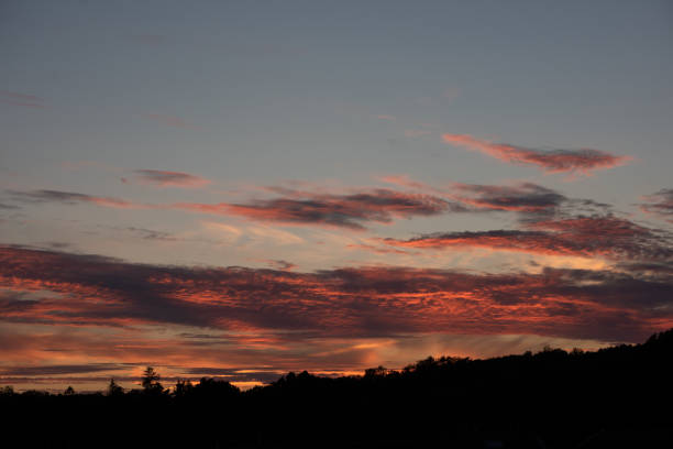 istock Red clouds lit up by the sun at sunset 1271263961