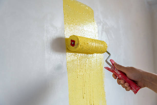 istock Workman painting the wall in yellow. 1271265207