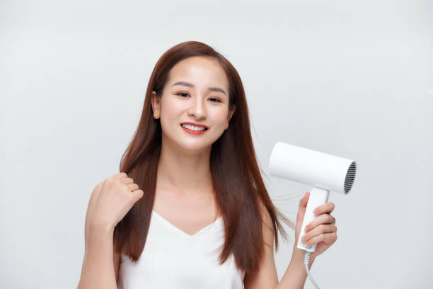 istock A young woman drying her hair 1271265476