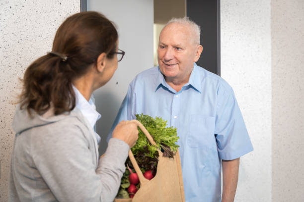 istock Woman helping senior man shopping 1271266833