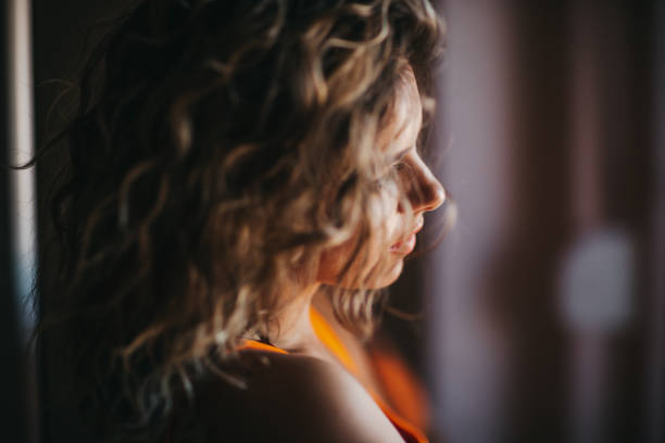 istock Woman by window 1271267881