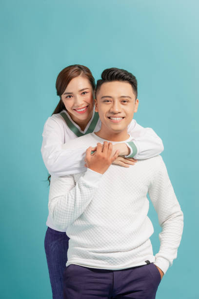 istock Happy smiling couple in love. Over blue background 1271267940