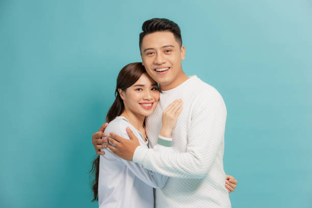 istock Happy smiling couple in love. Over blue background 1271267997