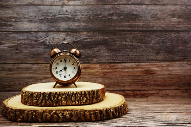 Vintage alarm clock with space copy on wooden background