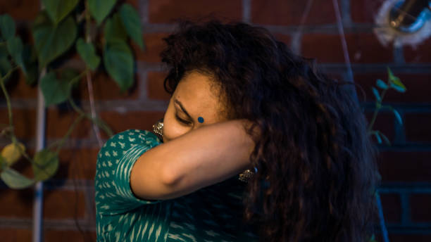 istock Indian woman playing with curly hairs 1271270173