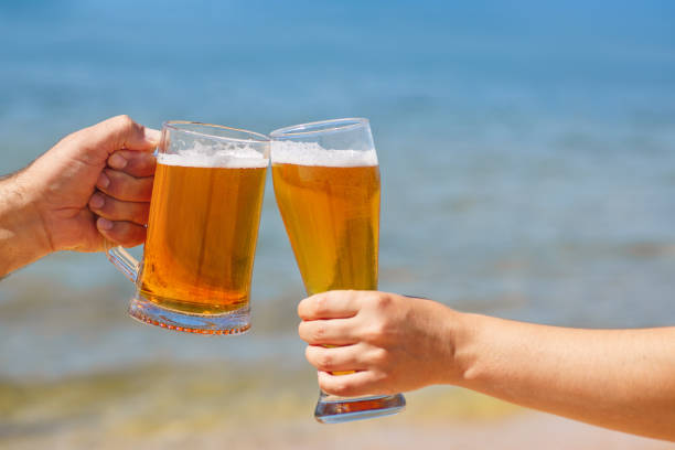 istock closeup hands holding glasses of beer 1271270220