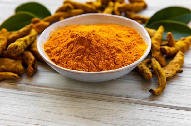 istock Turmeric powder and dry roots 1271270371