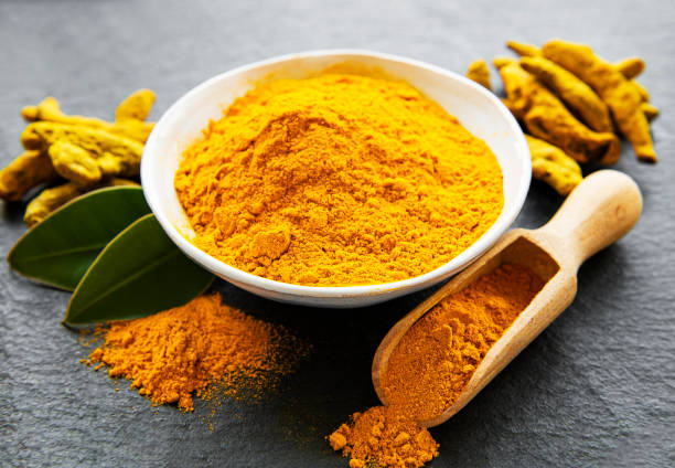 istock Turmeric powder and dry roots 1271270379