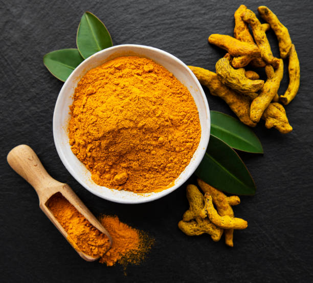 istock Turmeric powder and dry roots 1271270401