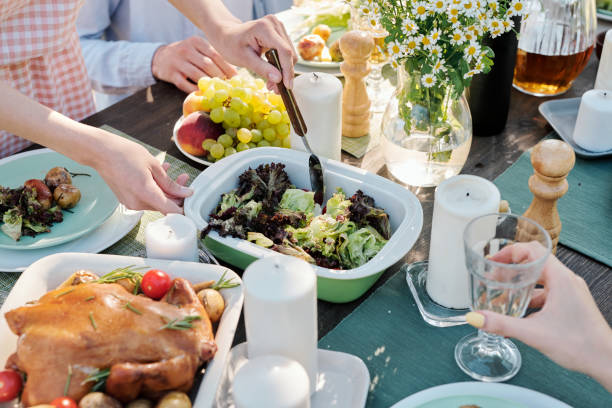 istock Hands of young female with spoon taking or mixing cooked vegetables on table 1271270787