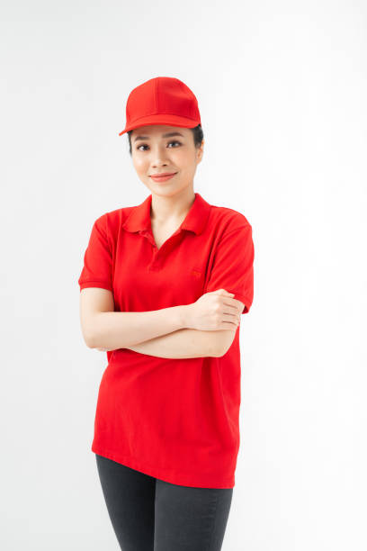istock Delivery woman in red uniform isolated on white background. 1271272650